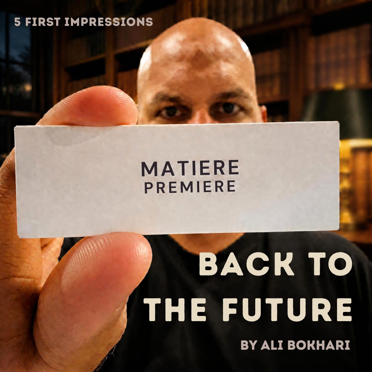 Matiere Premiere: Back to the Future Ali Bokhari holds a white Matiรจre Premiรจre sample box in front of his face, his eyes visible above it, against a softly lit library backdrop. Text reads "5 First Impressions," "Back to the Future" and "By Ali Bokhari."